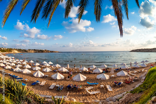 Undefinable Tourists relaxing on the beach in the summer vacation. Peyia village, Paphos District, Cyprus photo