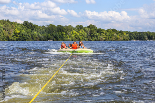 Quadro su tela People tubing on an inland lake