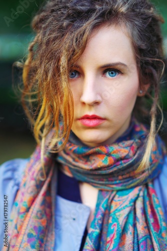 Portrait of young beautiful successful girl in scarf outdoors, closeup