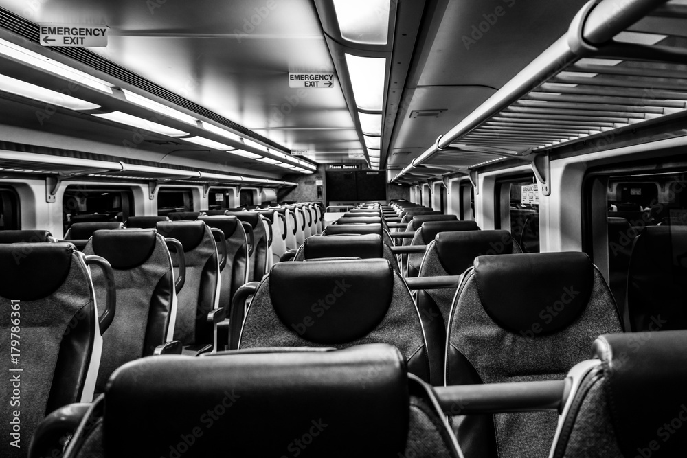 Dover, NJ USA - November 1, 2017:  New double-decker NJ Transit train at night with empty seats, black and white