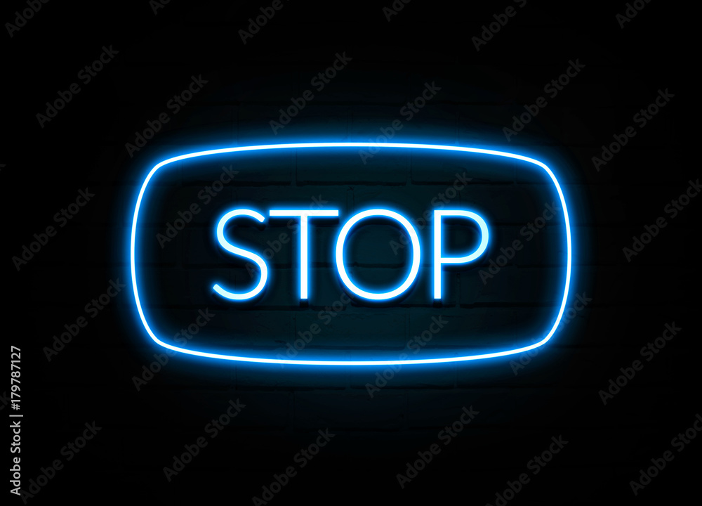 Stop  - colorful Neon Sign on brickwall
