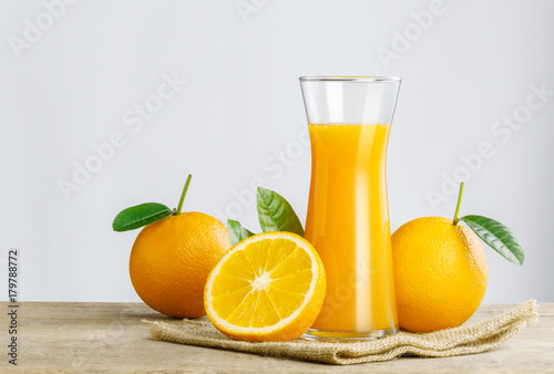 Bild auf Leinwand Glass of fresh orange juice on wooden table, Fresh fruits Orange juice in glass