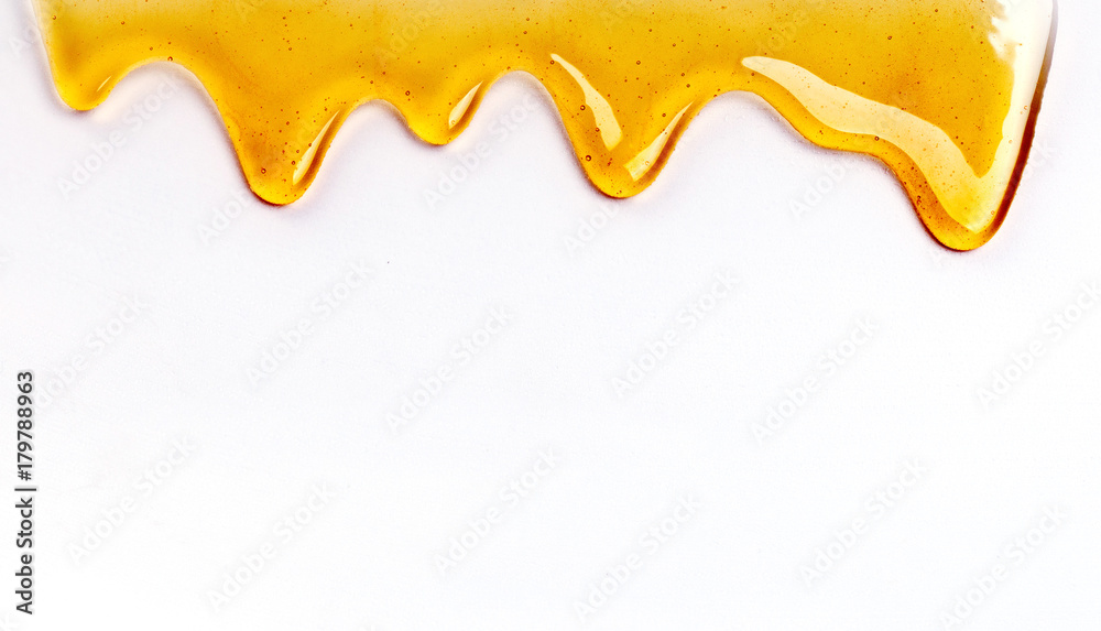 Dripping honey seamlessly repeatable from the top over white with copyspace. - obrazy, fototapety, plakaty 