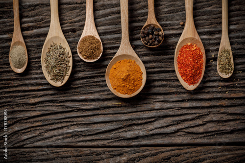 Herbs and spices and the spoon on the wooden table