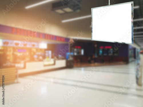 Blank billboard advertising hanging in front of movie theatre background blurred  commercial  marketing and advertisement concept