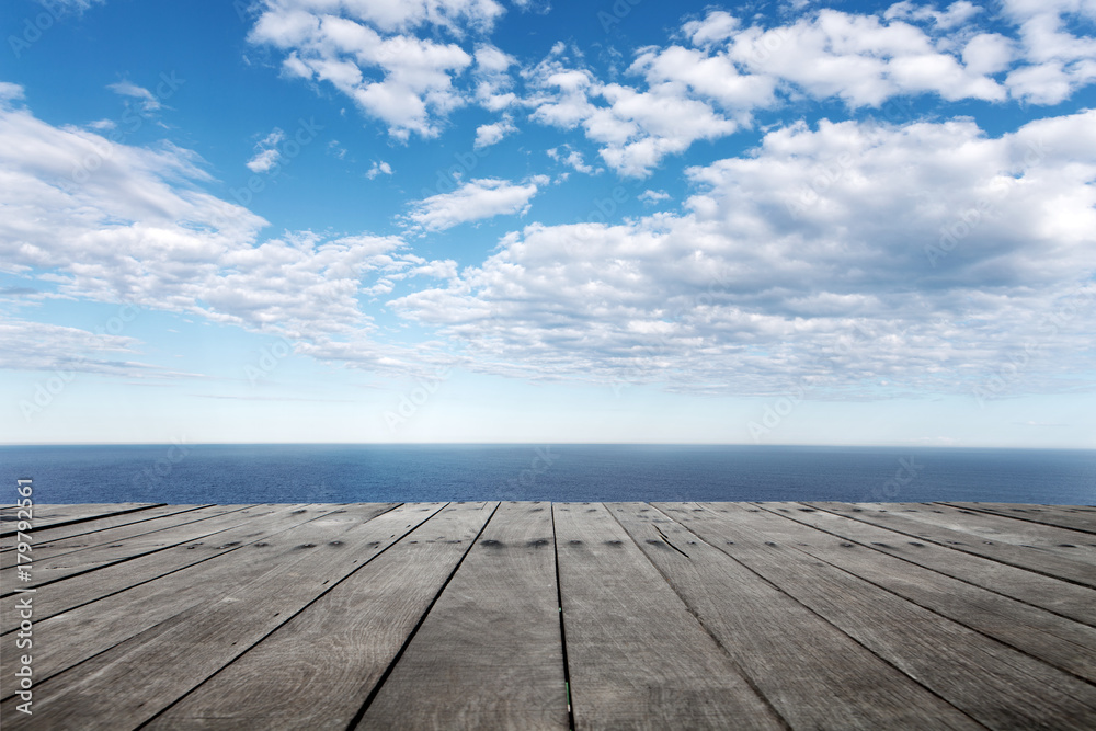 empty wooden floor with beautiful sea in blue cloud sky