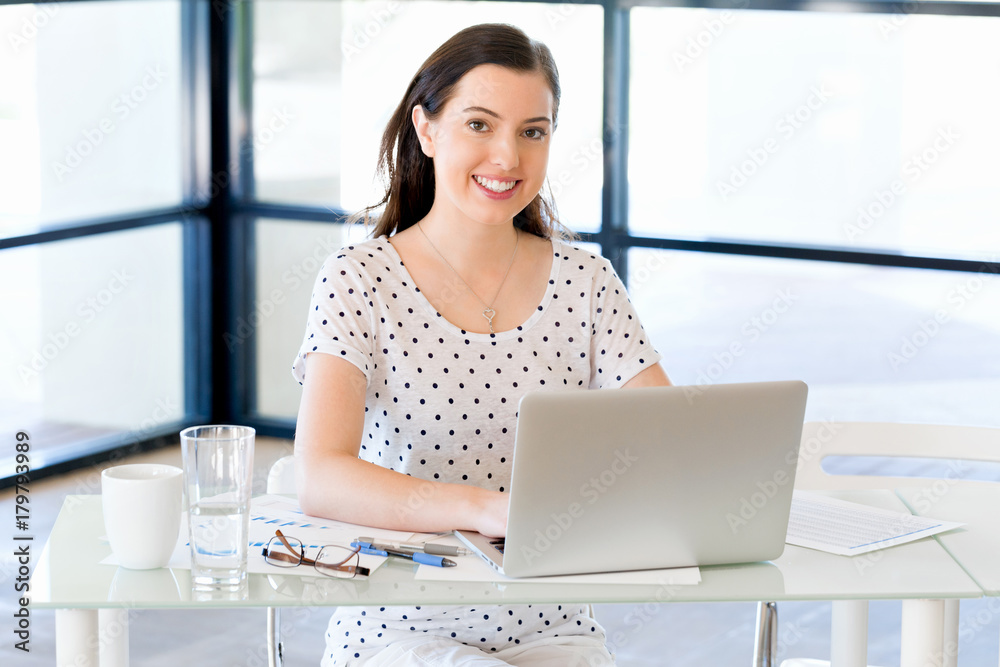 Portrait of businesswoman working at computer in office Portrait of businesswoman working at computer in office