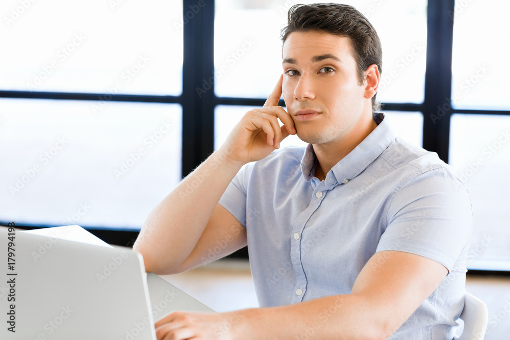 Handsome businessman working at computer Handsome businessman working at computer