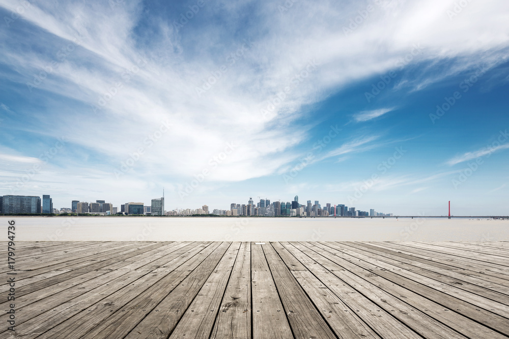 empty wooden floor with modern bridge and buildings empty wooden floor with modern bridge and buildings