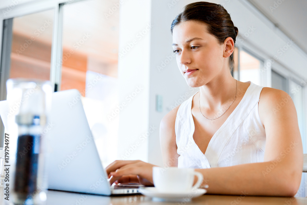 Young beautiful woman working on her laptop Young beautiful woman working on her laptop