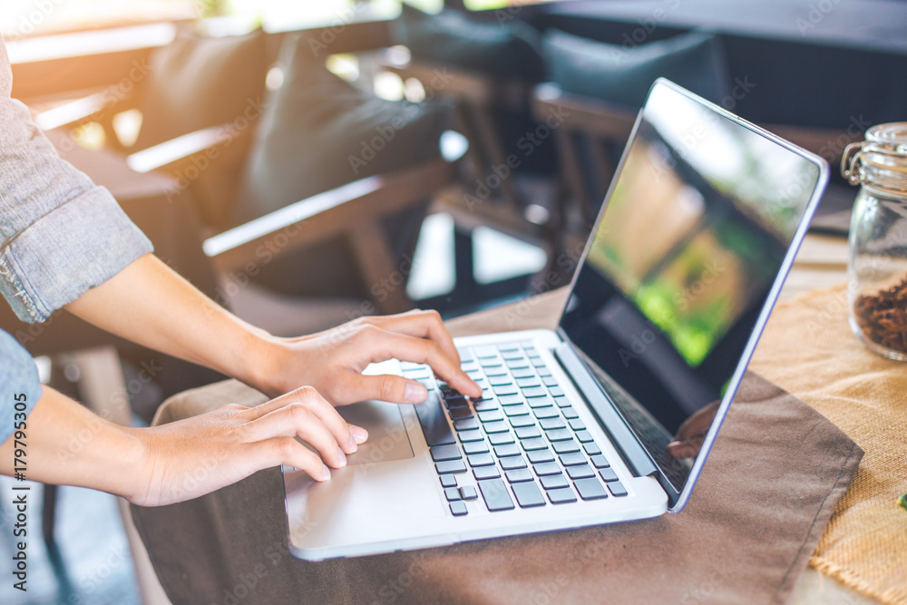 Woman hand works in a computer laptop in the office. Woman hand works in a computer laptop in the office.