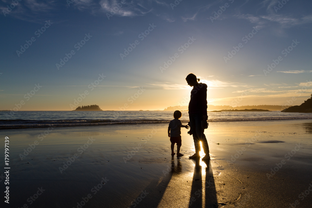 Fototapeta premium Family enjoying a sunset on the beach in the late summer near the town of Tofino on Vancouver Island
