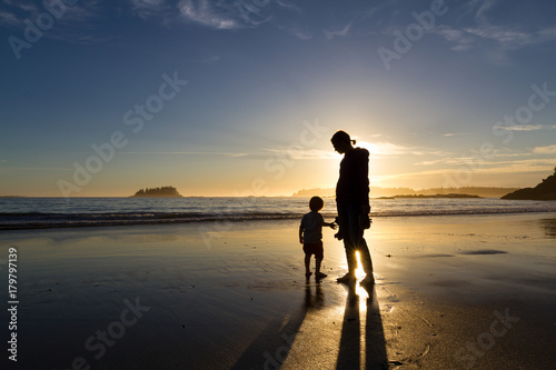 Family enjoying a sunset on the beach in the late summer near the town of Tofino on Vancouver Island