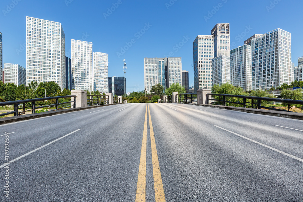 Asphalt road and urban commercial building scenery Asphalt road and urban commercial building scenery
