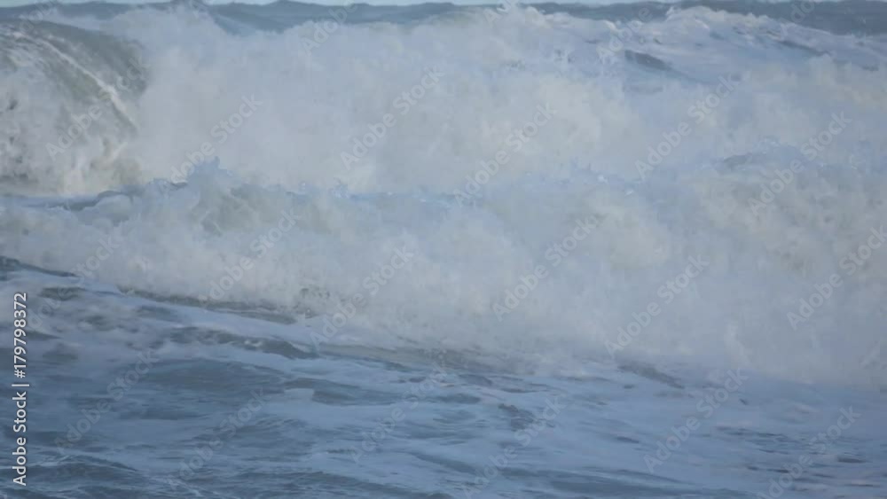 Waves rolling on the beach is a stormy day, winter mediterranean sea. Focene, Lazio, Italy. Slow motion Waves rolling on the beach is a stormy day, winter mediterranean sea. Focene, Lazio, Italy. Slow motion