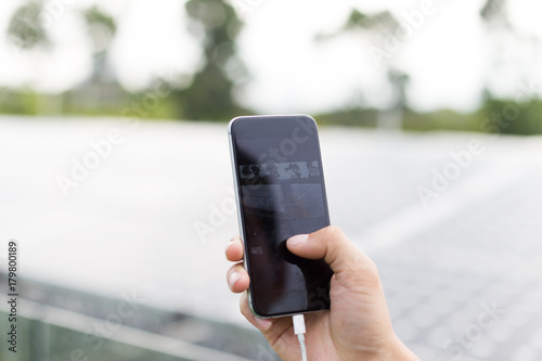 hand with mobile phone outdoors