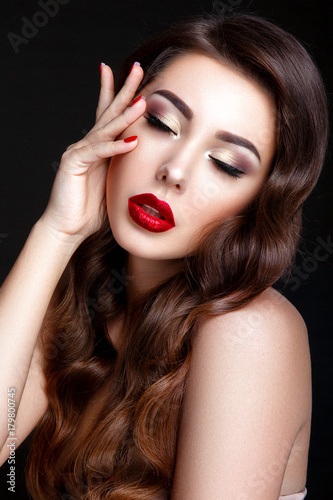 Beautiful woman portrait. Young lady posing close up on black background. Glamour make up  red lipstick  red nails. 