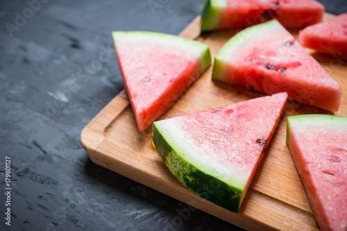 Watermelon slices on the rustic wooden background. Shallow depth of field.