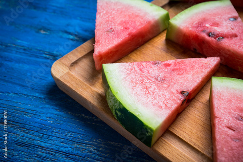Watermelon slices on the rustic wooden background. Shallow depth of field.