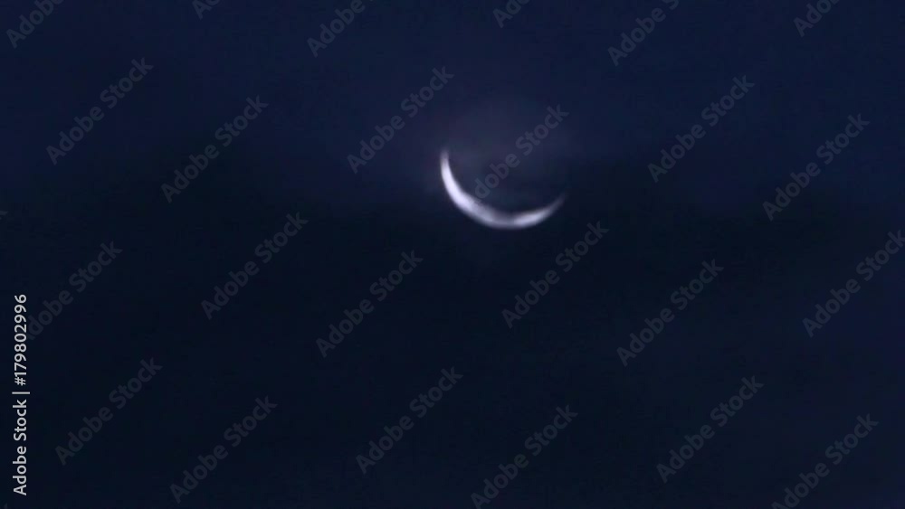A view of a crescent moon on a cloudy night. A view of a crescent moon on a cloudy night.