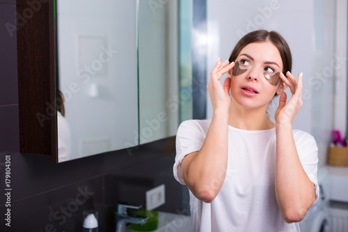 Woman with hydrogel eye patches