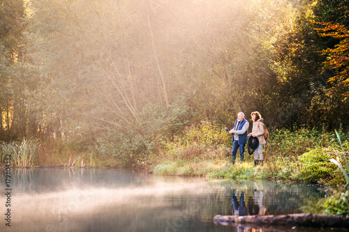 Senior couple fishing at the lake in autumn. © Halfpoint