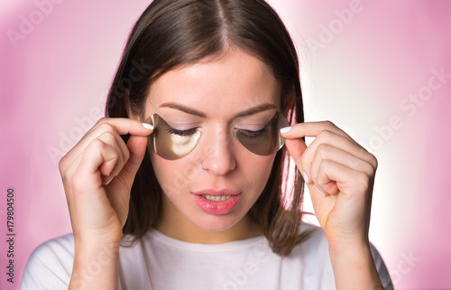 Woman with hydrogel eye patches