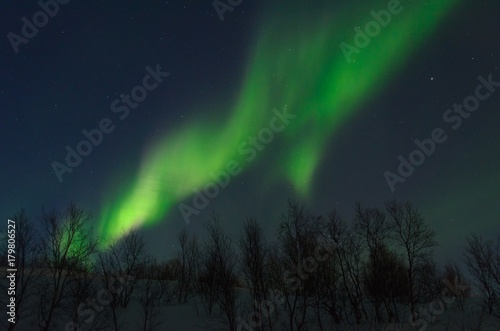 The Northern lights ,Aurora the night over the hills and forest.