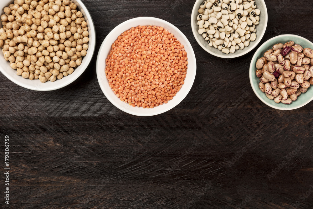 Legumes on dark background, from above with copy space Legumes on dark background, from above with copy space
