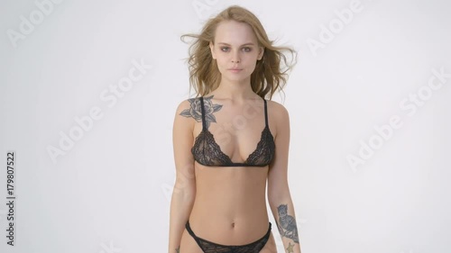 Young and beautiful fashion model posing in erotic lingerie over white background. Fashion, beauty, glamour concept.