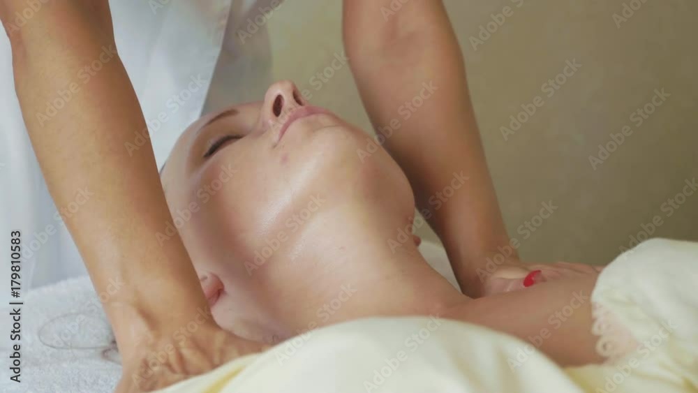 Beautiful young woman relaxing with face massage at luxury spa salon, close-up. Beautiful young woman relaxing with face massage at luxury spa salon, close-up.