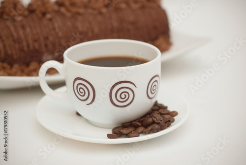 Cup of Coffee with Chocolate Cake on White Table. close Up. Isolated Dessert.