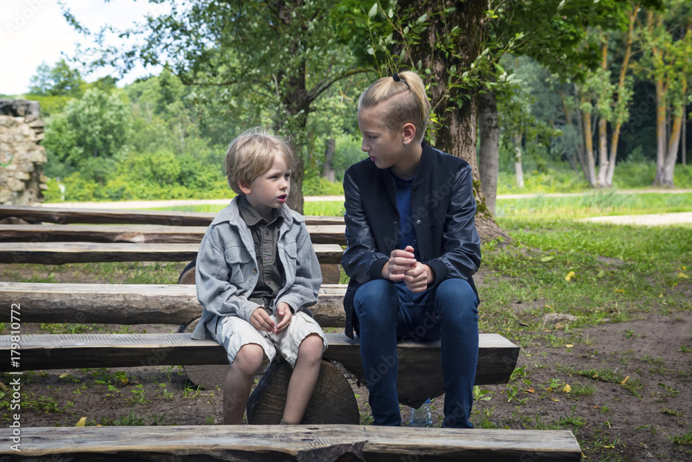 Brothers sit on a bench Brothers sit on a bench