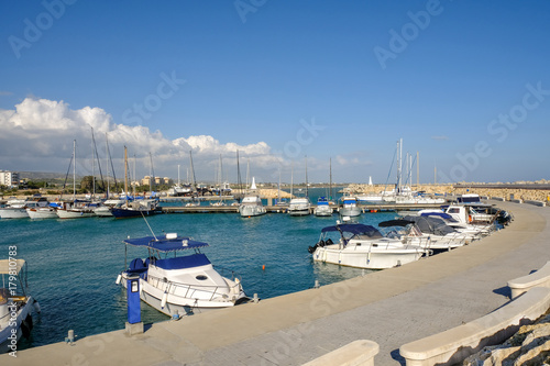 Boats moored in the harbour at Zygi, Cyprus. Taken on a bright blue sky day. 
