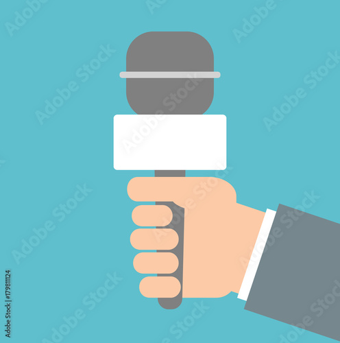 Hand holding reporter microphone