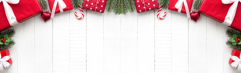 Christmas gift boxes with decorating ornaments on white wood background border design