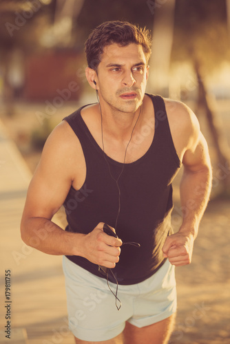 Man jogging on city seafront
