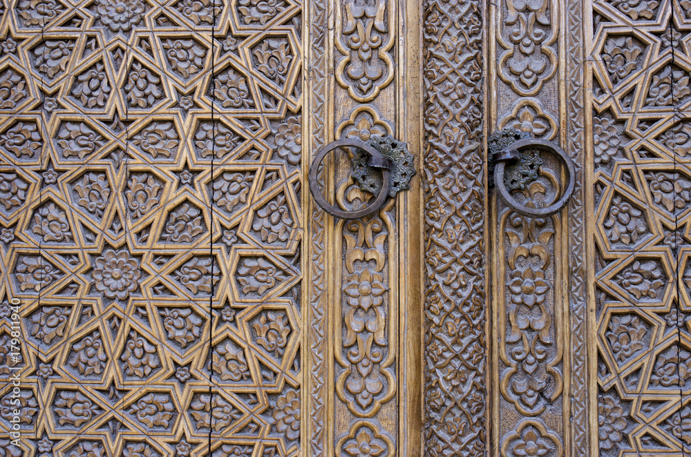 An old wood door with metal handle. Details of Muslim architecture.