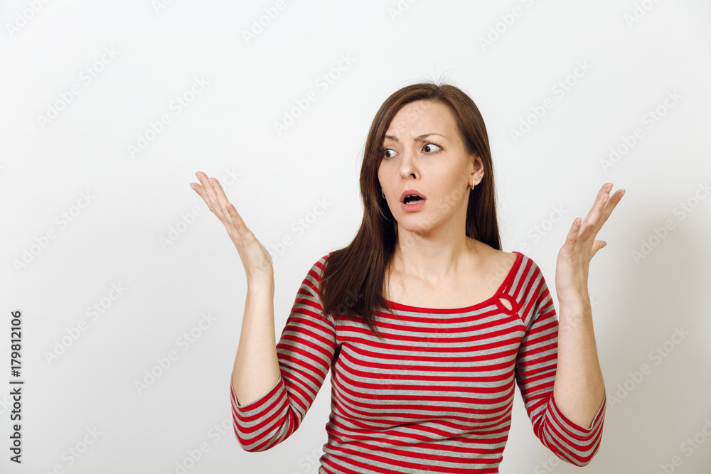 Pretty European young worried and pensive brown-haired woman with healthy clean skin, dressed in casual red and grey clothes lost in thought and conjectures, on a white background. Emotions concept. Pretty European young worried and pensive brown-haired woman with healthy clean skin, dressed in casual red and grey clothes lost in thought and conjectures, on a white background. Emotions concept.