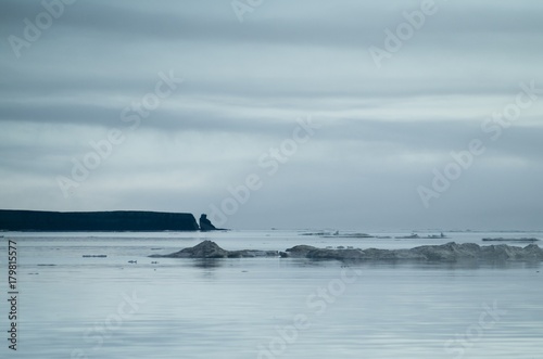Ice in the Arctic Ocean and a view of the shore of the polar island