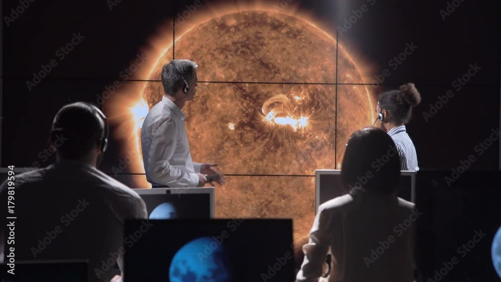 Multiracial team of scientists investigating and analyzing solar eclipse and solar activity. Elements of this image furnished by NASA.