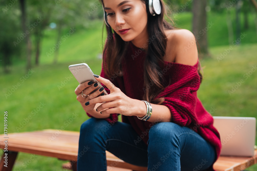 Cropped image of a pretty asian girl in headphones Cropped image of a pretty asian girl in headphones