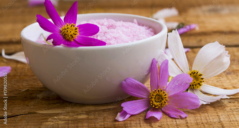 Spa setting with bath salt, floral bath salt bowl on wooden table, wellness and spa concept Spa setting with bath salt, floral bath salt bowl on wooden table, wellness and spa concept