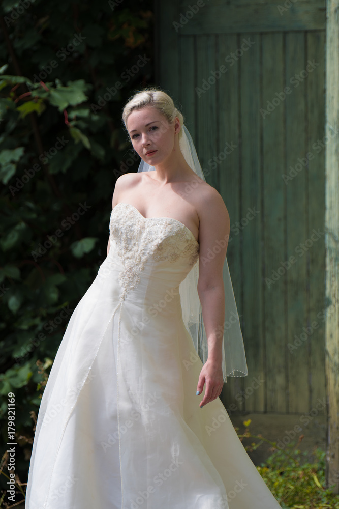 Young bride in the urban decay environment of Platt's Eyot Island in Hampshire UK Young bride in the urban decay environment of Platt's Eyot Island in Hampshire UK