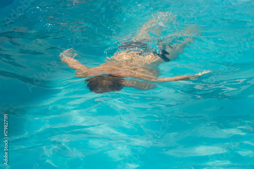 Man swims in the pool. 