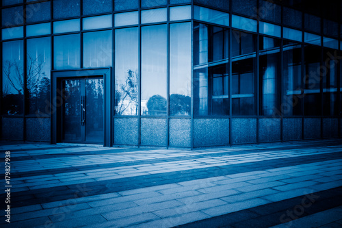 empty pavement front of the modern office entrance.