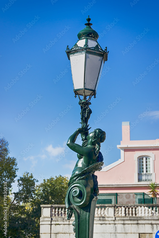 Interesting street lamp, sculpture woman. Details. Lisbon, Portugal