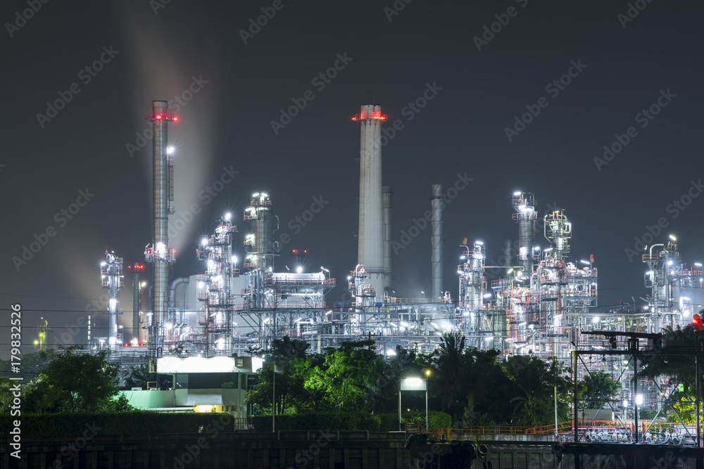 Oil refinery along the river at the early morning.