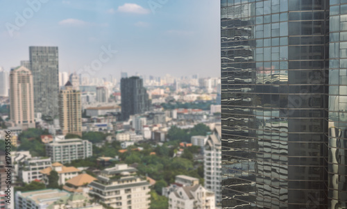 High building in foreground and blurred cityscape on background