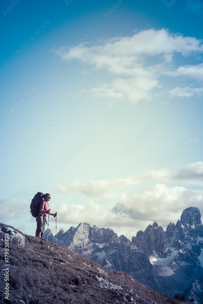 hiker in front of Alps mountains